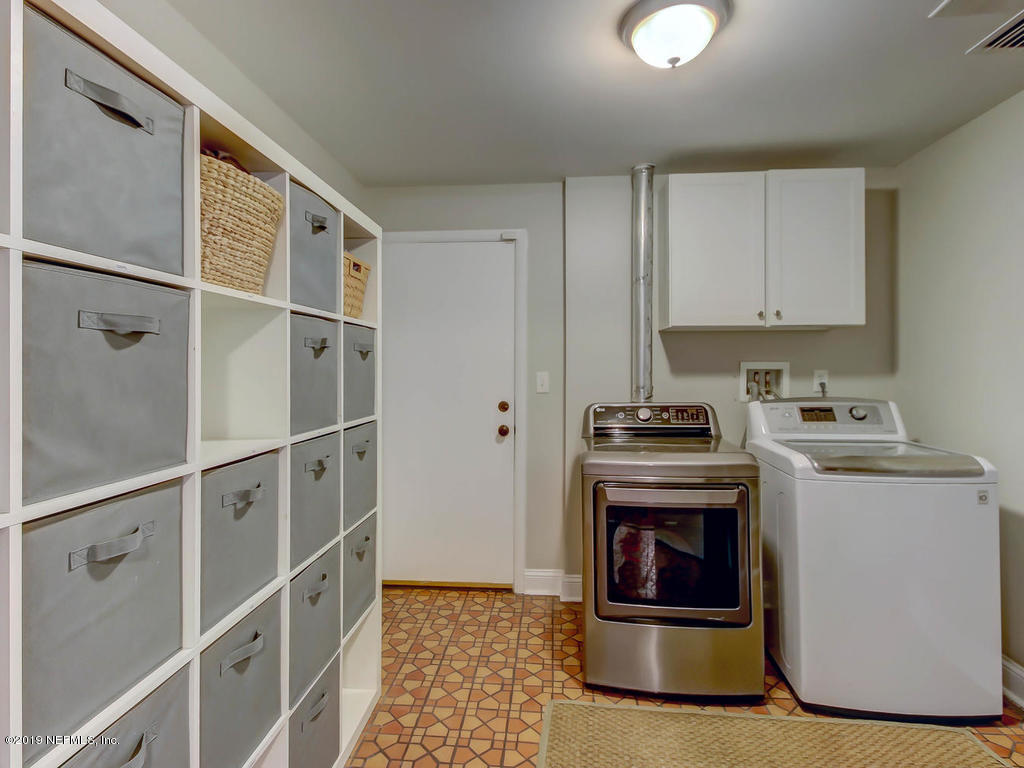 945 Mapleton Terrace Jacksonville, FL 32207 - Photo 24 of 45 a kitchen with stove cabinets and stainless steel appliances