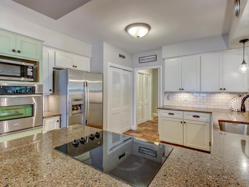 945 Mapleton Terrace Jacksonville, FL 32207 - Photo 29 of 45 a kitchen with stainless steel appliances granite countertop a stove refrigerator and cabinets
