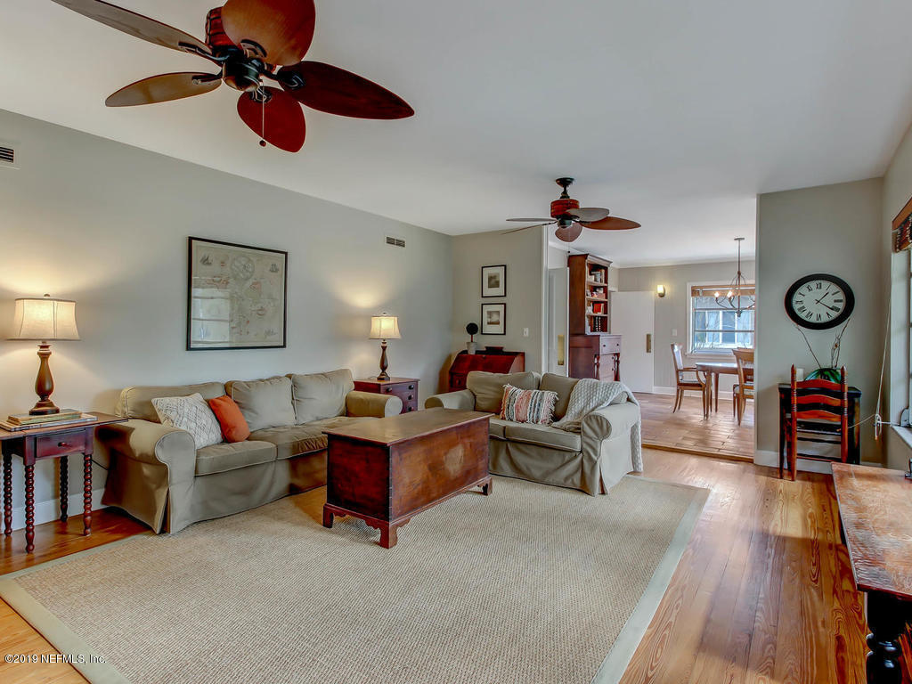 945 Mapleton Terrace Jacksonville, FL 32207 - Photo 3 of 45 a living room with furniture and a chandelier