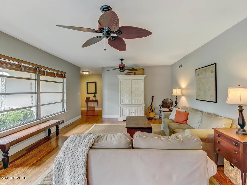 945 Mapleton Terrace Jacksonville, FL 32207 - Photo 31 of 45 a bedroom with a large bed and a chandelier