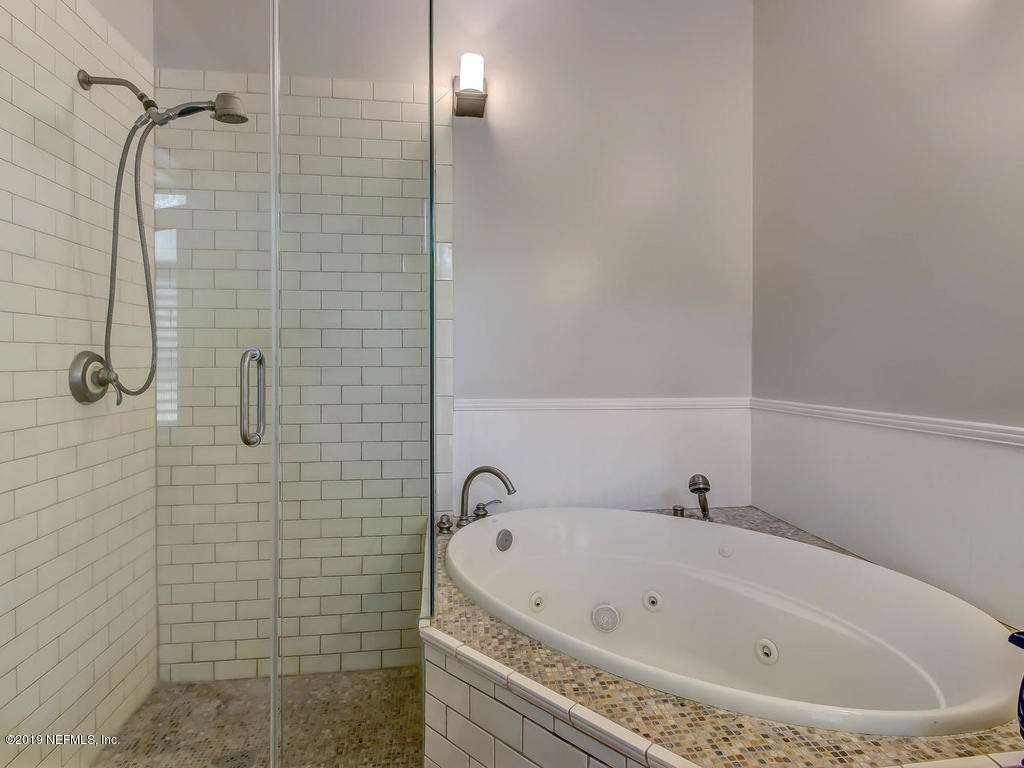 945 Mapleton Terrace Jacksonville, FL 32207 - Photo 37 of 45 a bathroom with a white bath tub and shower