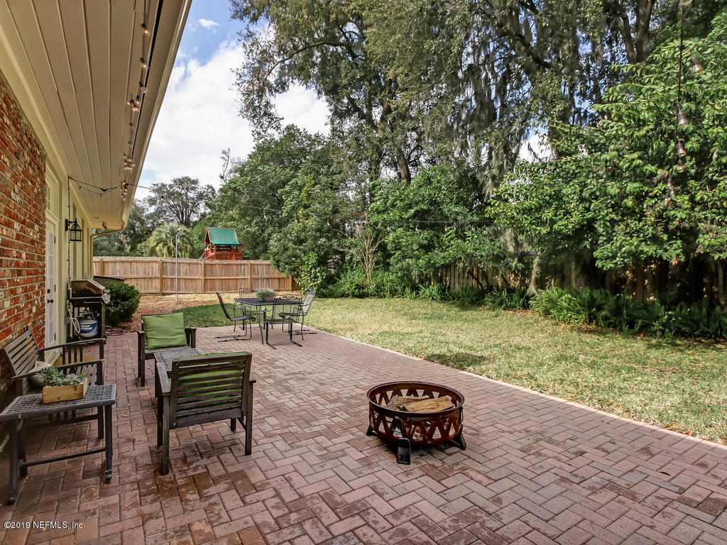 945 Mapleton Terrace Jacksonville, FL 32207 - Photo 38 of 45 a backyard of a house with table and chairs