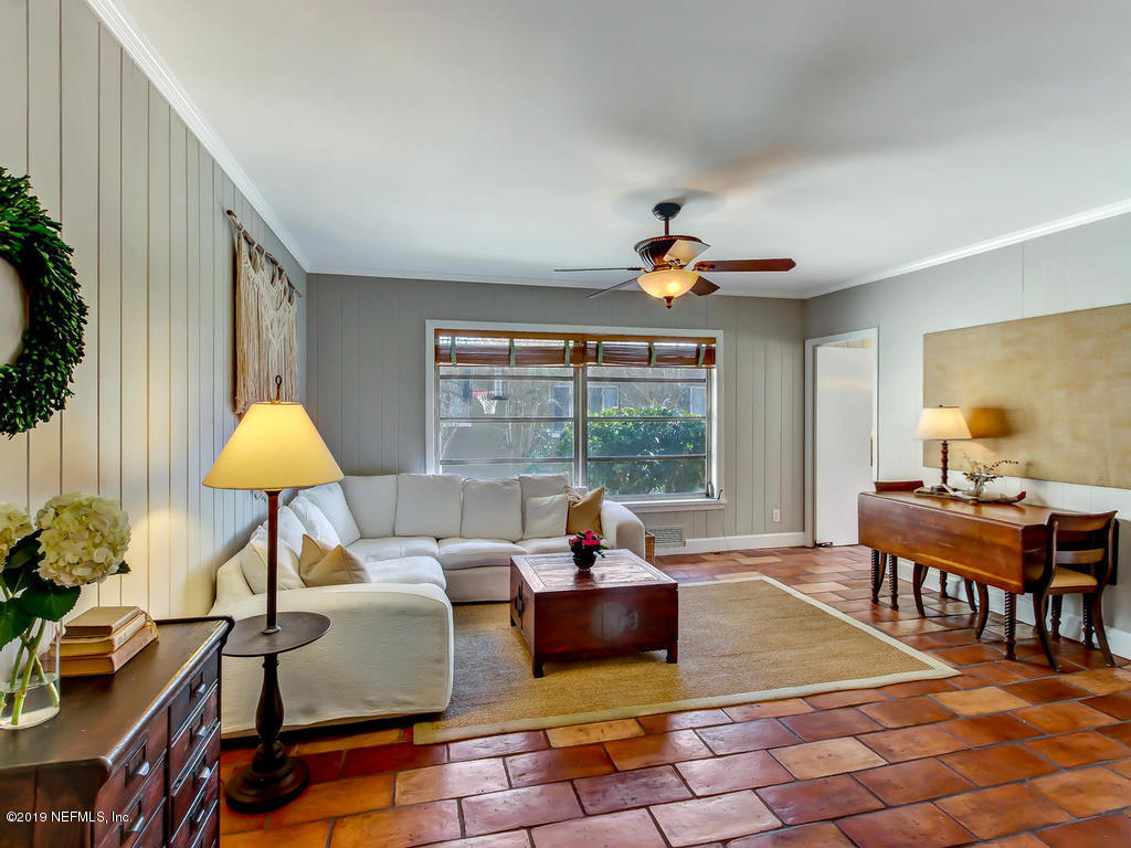945 Mapleton Terrace Jacksonville, FL 32207 - Photo 6 of 45 a living room with furniture and a floor to ceiling window