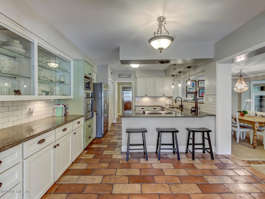 945 Mapleton Terrace Jacksonville, FL 32207 - Photo 7 of 45 a large kitchen with kitchen island a sink table and chairs