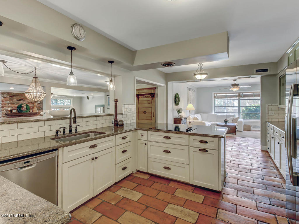945 Mapleton Terrace Jacksonville, FL 32207 - Photo 9 of 45 a kitchen with sink cabinets and stove