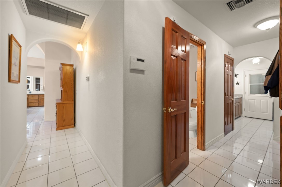 3516 Packsaddle Road Kingman, AZ 86401 - Photo 56 of 100 Hallway Leading to half bath, laundry room and garages