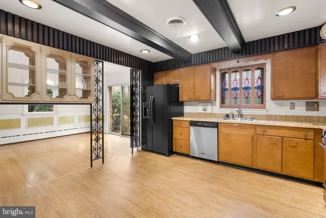 a kitchen with a refrigerator and a sink