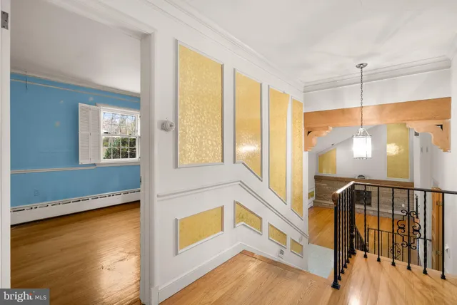 a view of a large kitchen with wooden floor and a window