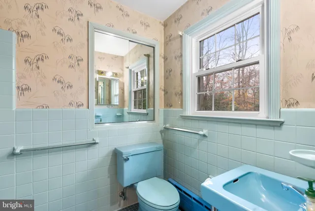 a bathroom with a toilet sink and window