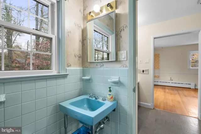 a bathroom with a sink and a window