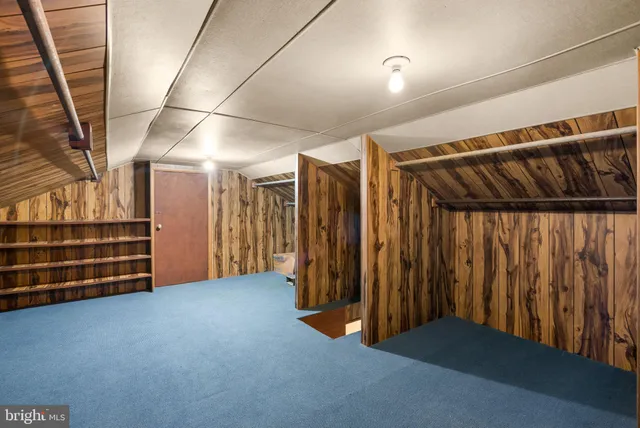 a view of an empty room with wooden walls