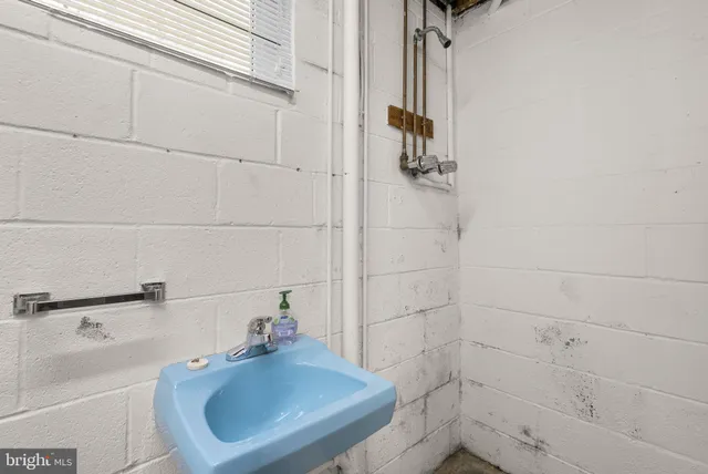 a bathroom with a sink and a window