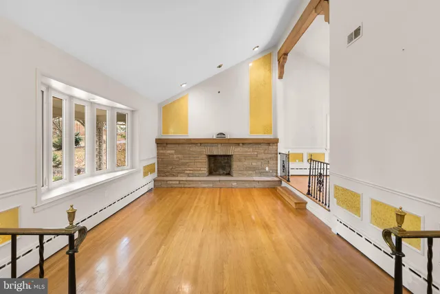 a view of an empty room with a fireplace and a window