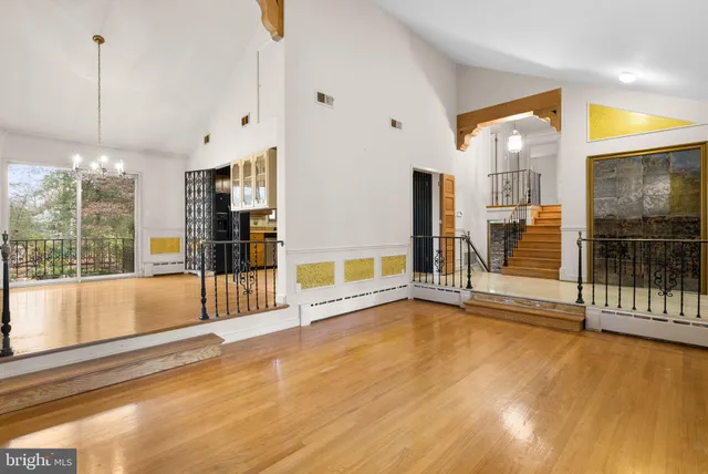 a view of an empty room with glass door and windows