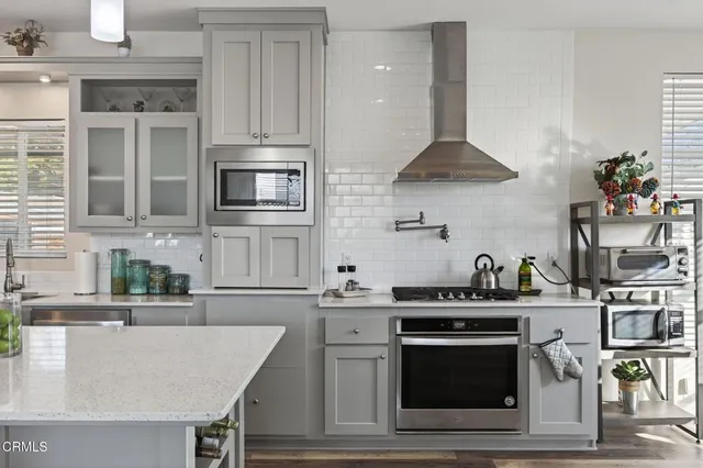 a kitchen with stainless steel appliances a stove a sink a stove and cabinets