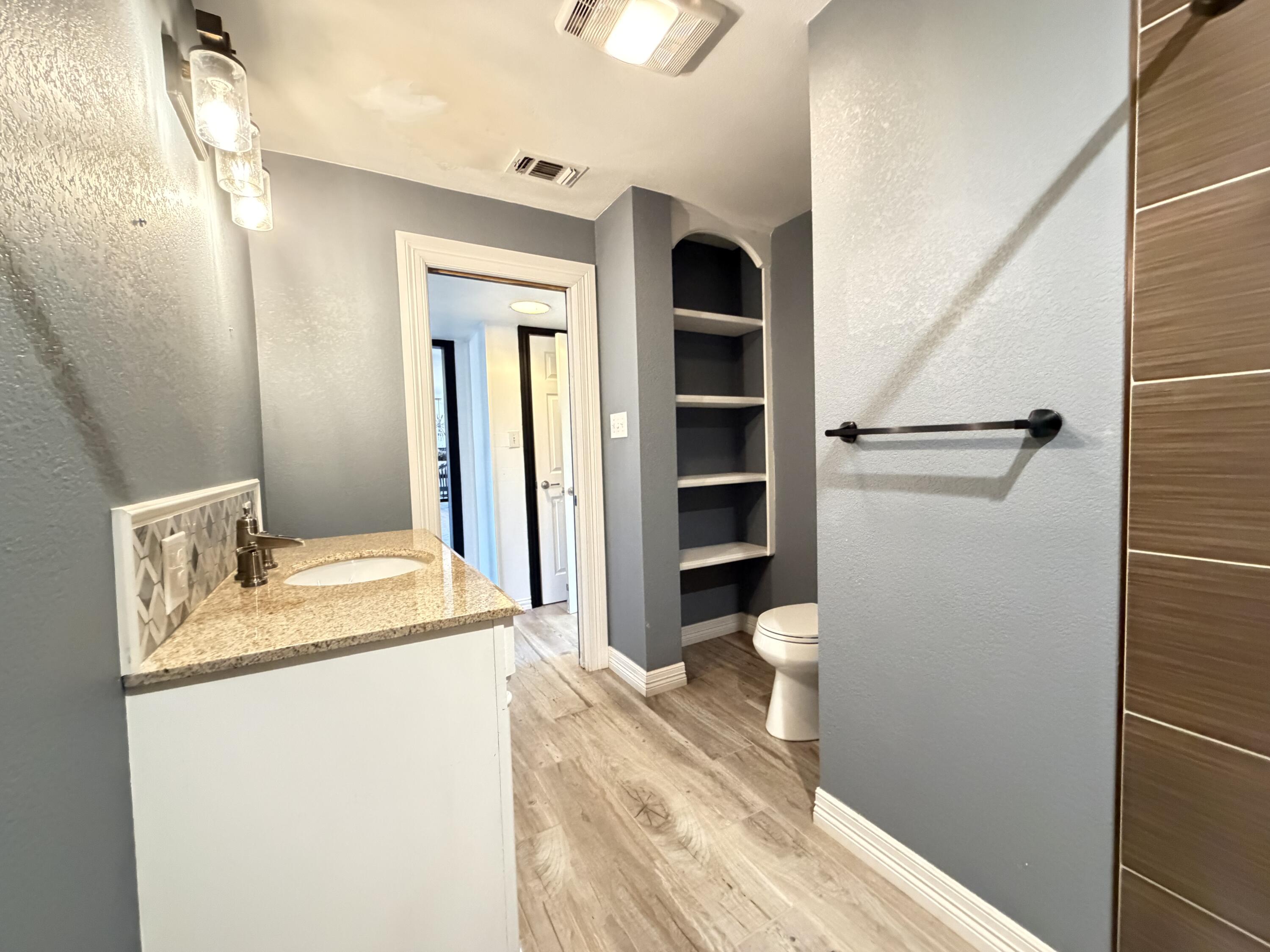 209 East 15th Street Littlefield, TX 79339 - Photo 12 of 18 a bathroom with a sink and a toilet