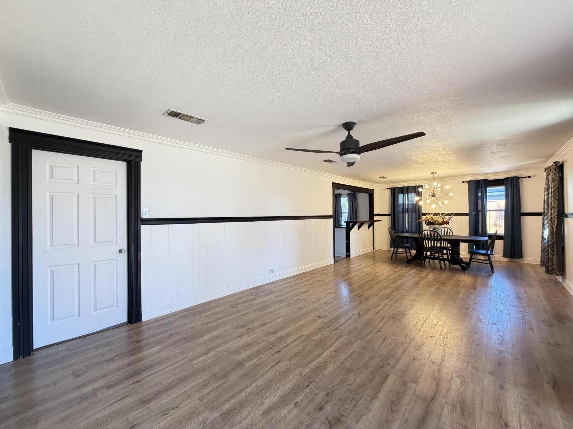 209 East 15th Street Littlefield, TX 79339 - Photo 3 of 18 a view of a livingroom with hardwood floor and a ceiling fan