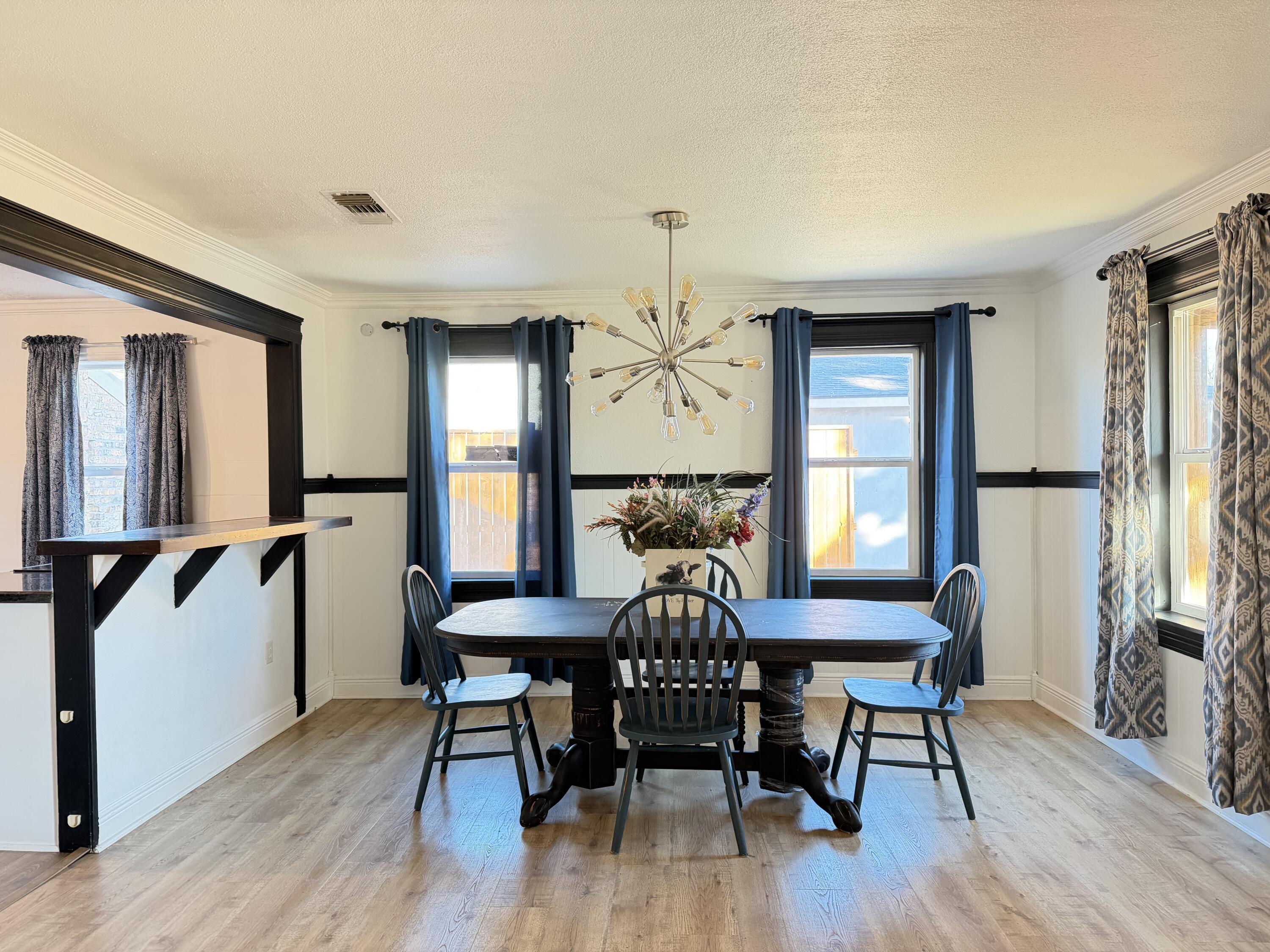 209 East 15th Street Littlefield, TX 79339 - Photo 4 of 18 a view of a dining room with furniture window and wooden floor
