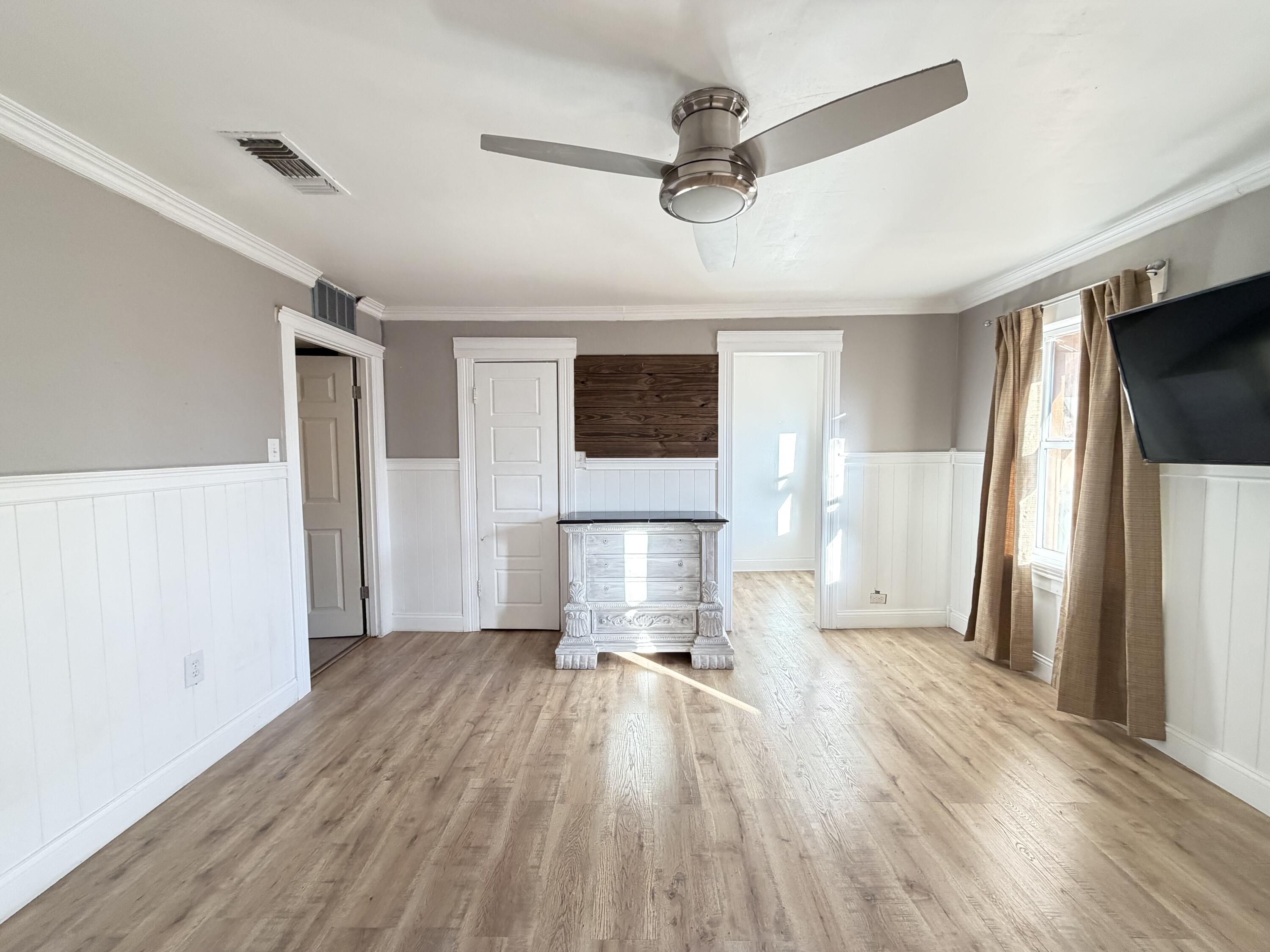 209 East 15th Street Littlefield, TX 79339 - Photo 8 of 18 a view of empty room with wooden floor