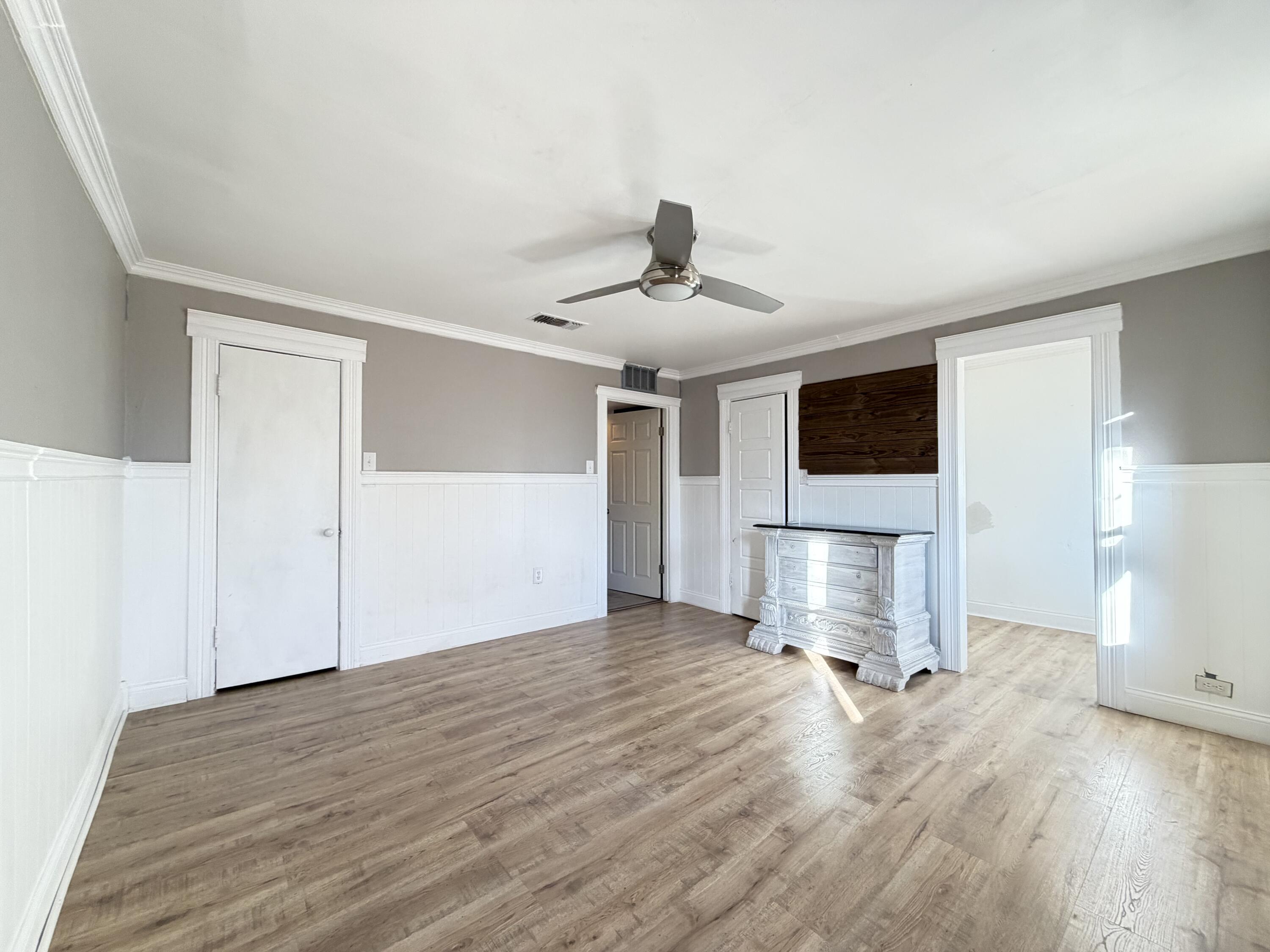 209 East 15th Street Littlefield, TX 79339 - Photo 9 of 18 a view of empty room with wooden floor and kitchen