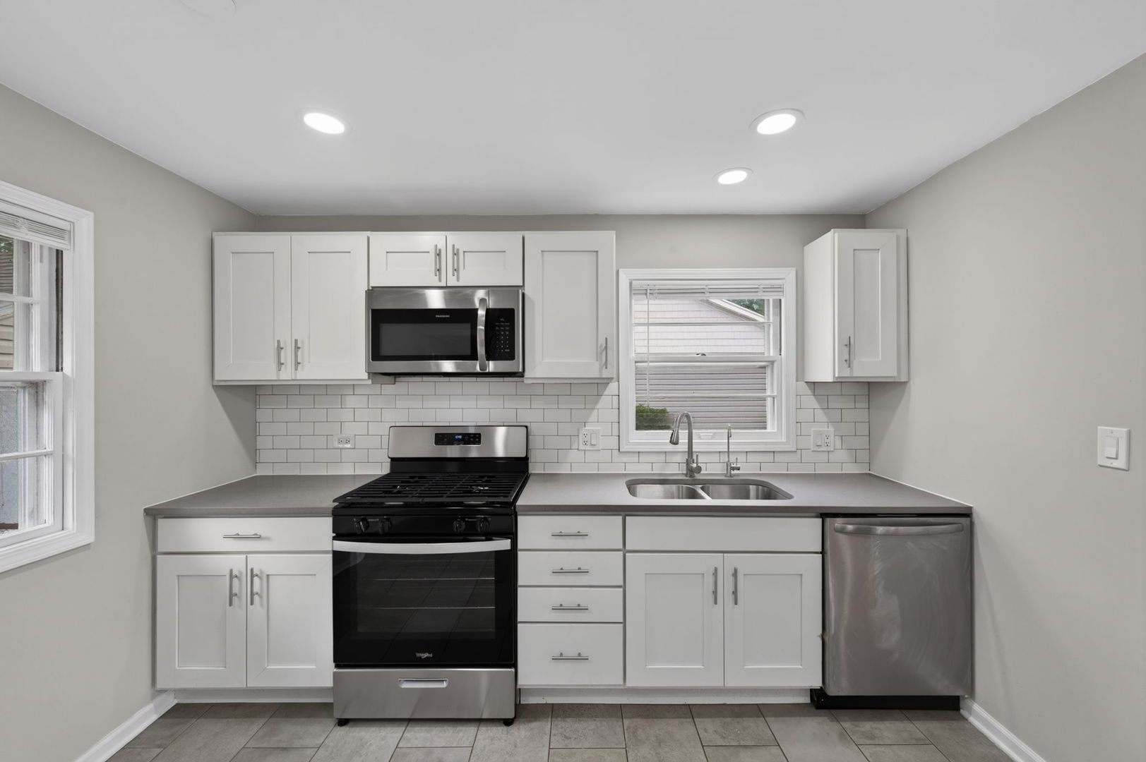 415 Alma Terrace Cary, IL 60013 - Photo 11 of 23 a kitchen with white cabinets and stainless steel appliances