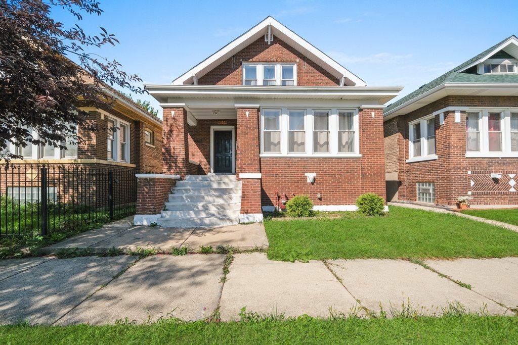 8014 South May Street Chicago, IL 60620 - Photo 1 of 50 a front view of a house with a yard