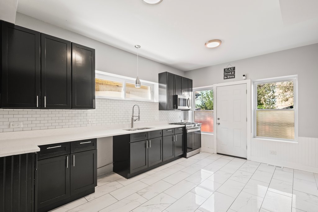 8014 South May Street Chicago, IL 60620 - Photo 11 of 50 a kitchen with a sink cabinets and window