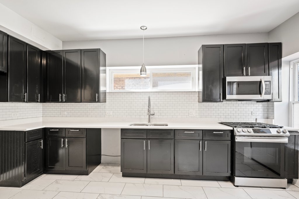 8014 South May Street Chicago, IL 60620 - Photo 13 of 50 a kitchen with a sink and a stove top oven