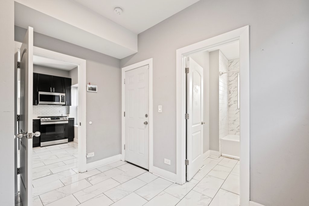 8014 South May Street Chicago, IL 60620 - Photo 17 of 50 a view of a livingroom and a hallway