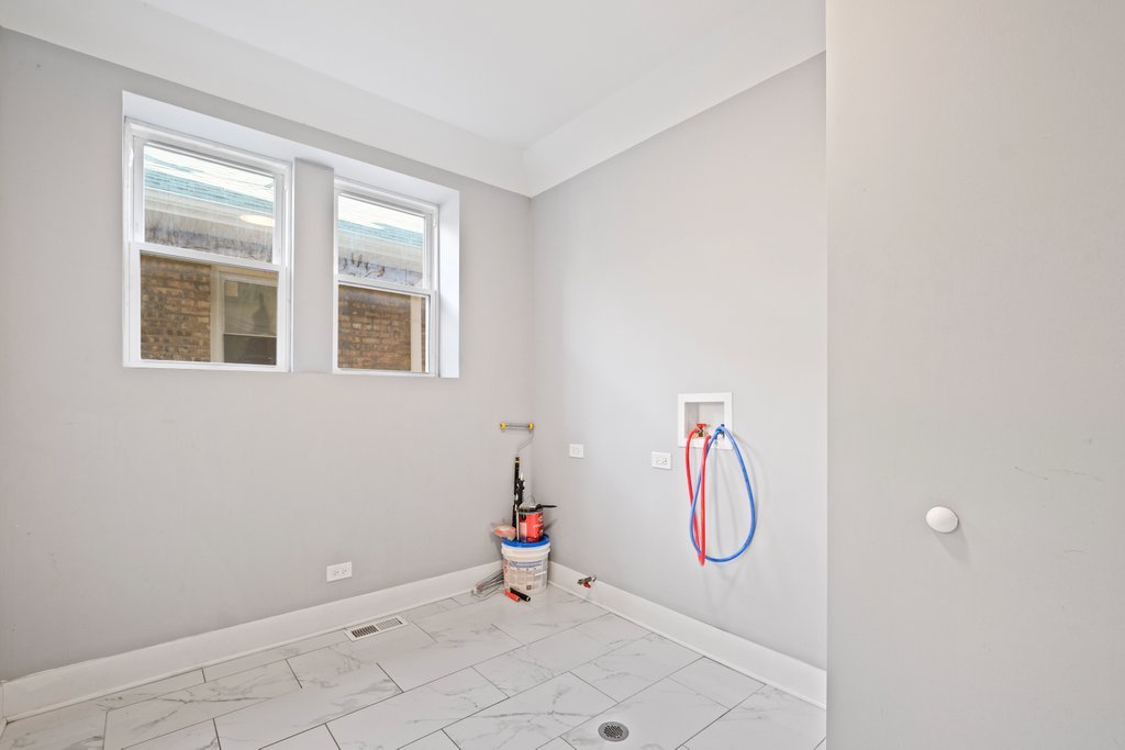 8014 South May Street Chicago, IL 60620 - Photo 19 of 50 a room with rack on the wall and a window