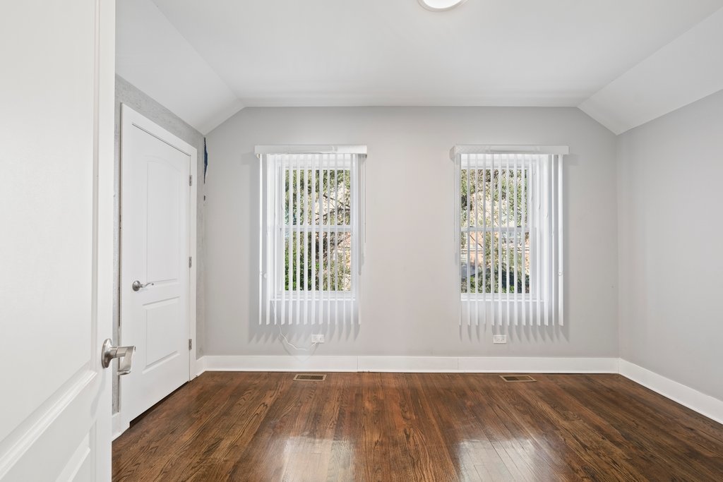 8014 South May Street Chicago, IL 60620 - Photo 20 of 50 an empty room with wooden floor and windows