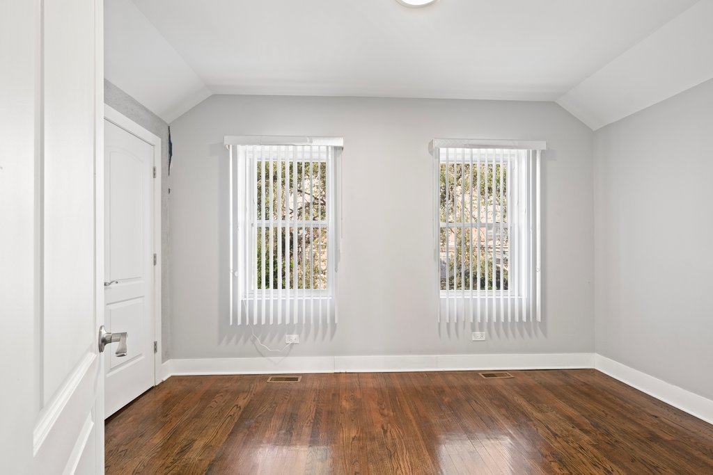 8014 South May Street Chicago, IL 60620 - Photo 21 of 50 an empty room with wooden floor and windows