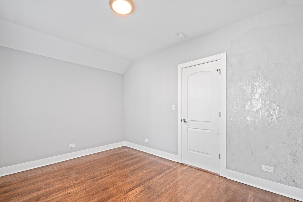 8014 South May Street Chicago, IL 60620 - Photo 22 of 50 a view of an empty room with wooden floor