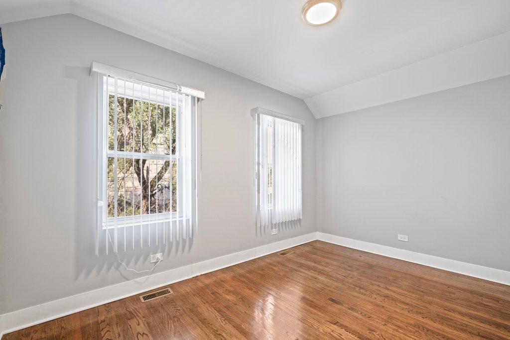8014 South May Street Chicago, IL 60620 - Photo 23 of 50 an empty room with wooden floor and windows