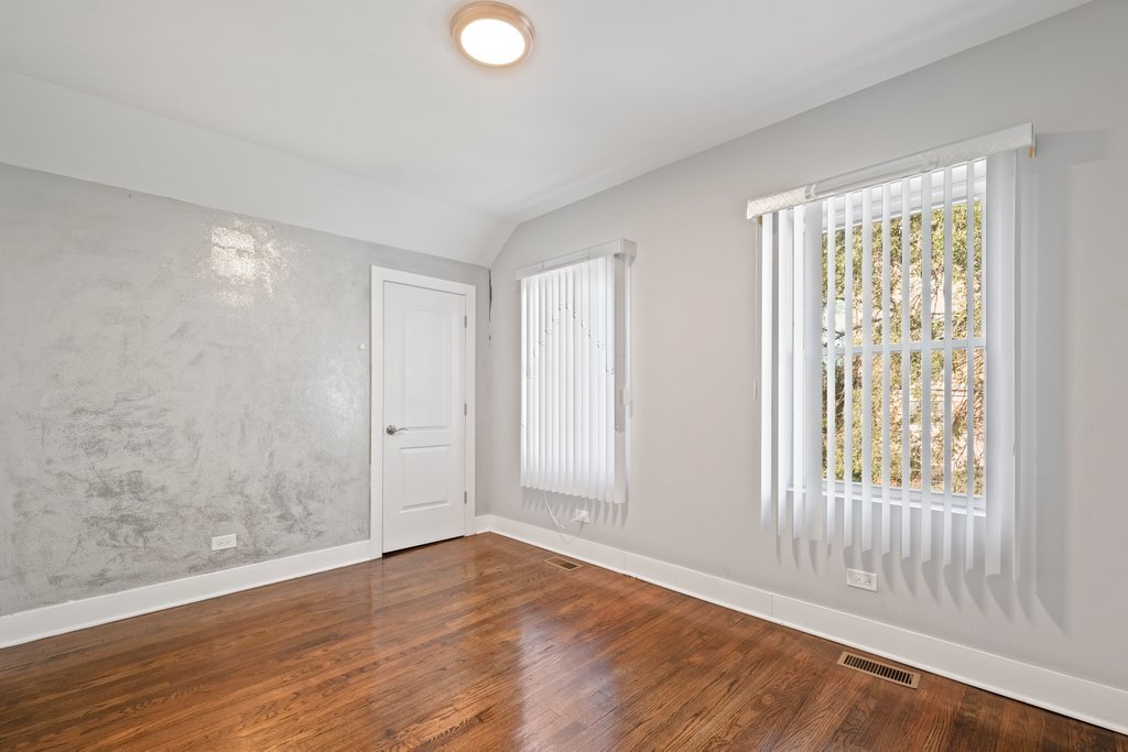 8014 South May Street Chicago, IL 60620 - Photo 24 of 50 an empty room with wooden floor and windows