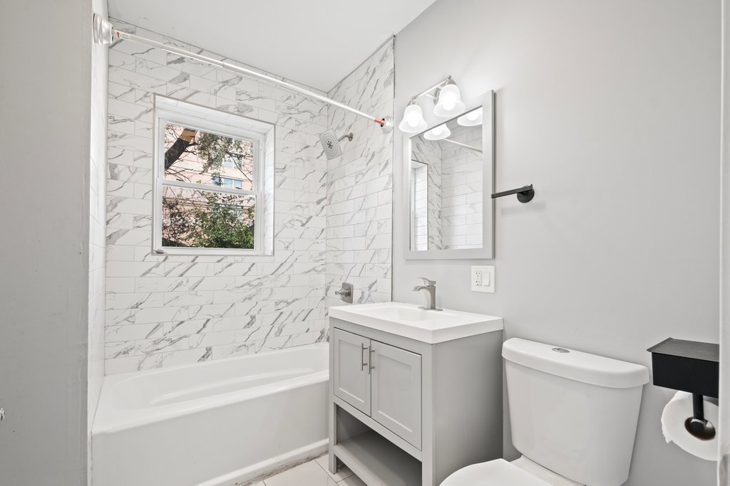 8014 South May Street Chicago, IL 60620 - Photo 25 of 50 a bathroom with a sink toilet and shower