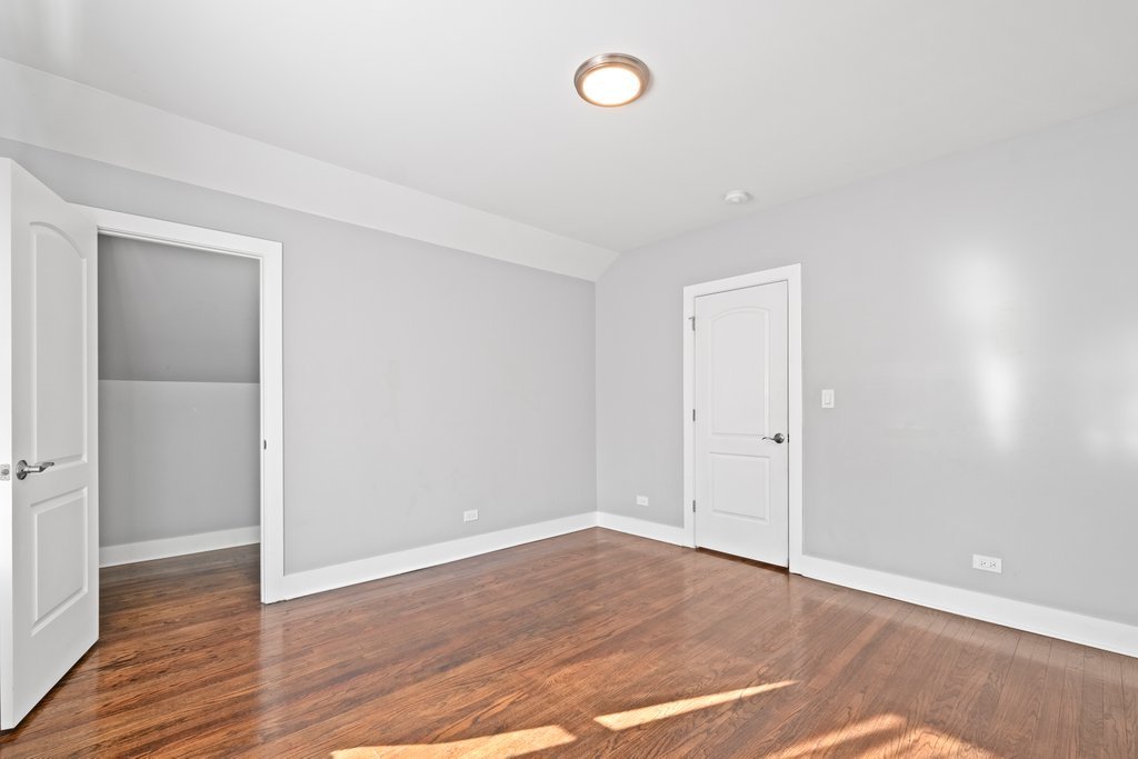8014 South May Street Chicago, IL 60620 - Photo 26 of 50 a view of an empty room with wooden floor