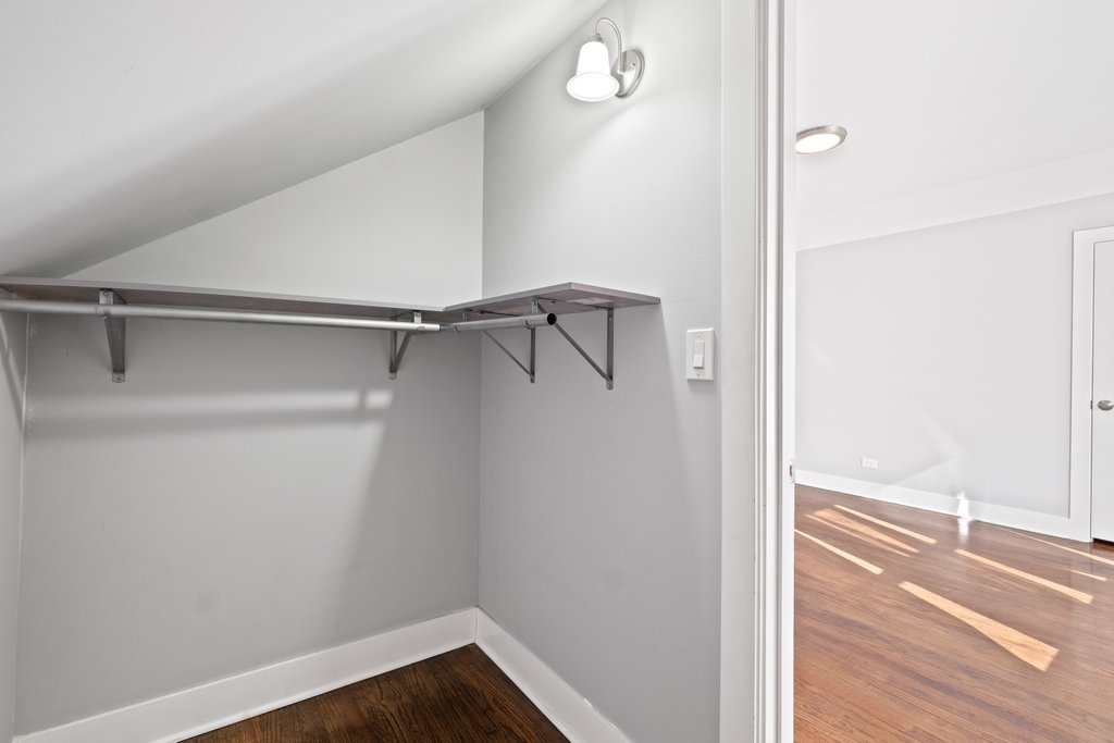 8014 South May Street Chicago, IL 60620 - Photo 28 of 50 a view of walk in closet with empty racks