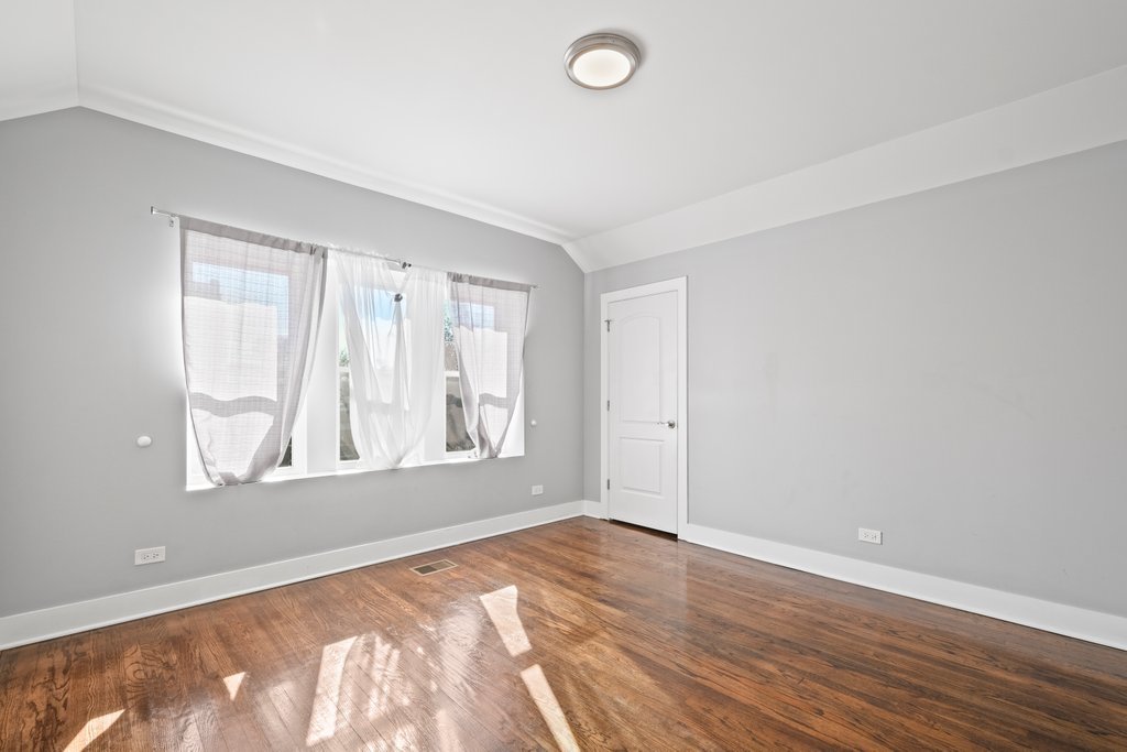 8014 South May Street Chicago, IL 60620 - Photo 29 of 50 an empty room with wooden floor and windows