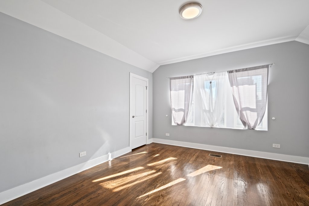 8014 South May Street Chicago, IL 60620 - Photo 30 of 50 an empty room with wooden floor and windows