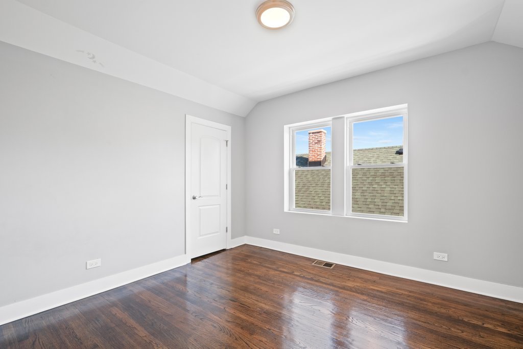 8014 South May Street Chicago, IL 60620 - Photo 37 of 50 an empty room with wooden floor and windows
