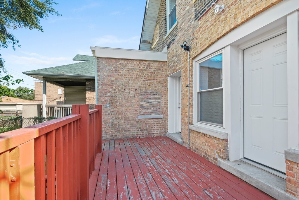 8014 South May Street Chicago, IL 60620 - Photo 45 of 50 a view of deck with wooden floor and fence