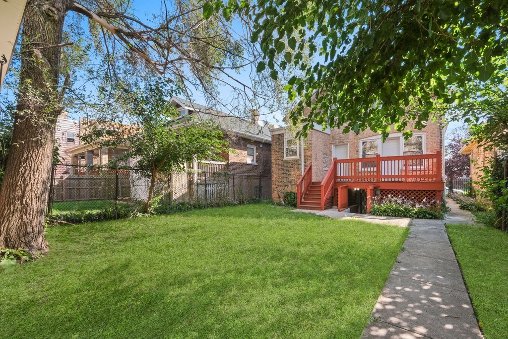 8014 South May Street Chicago, IL 60620 - Photo 47 of 50 a view of a backyard with table and chairs and a large tree