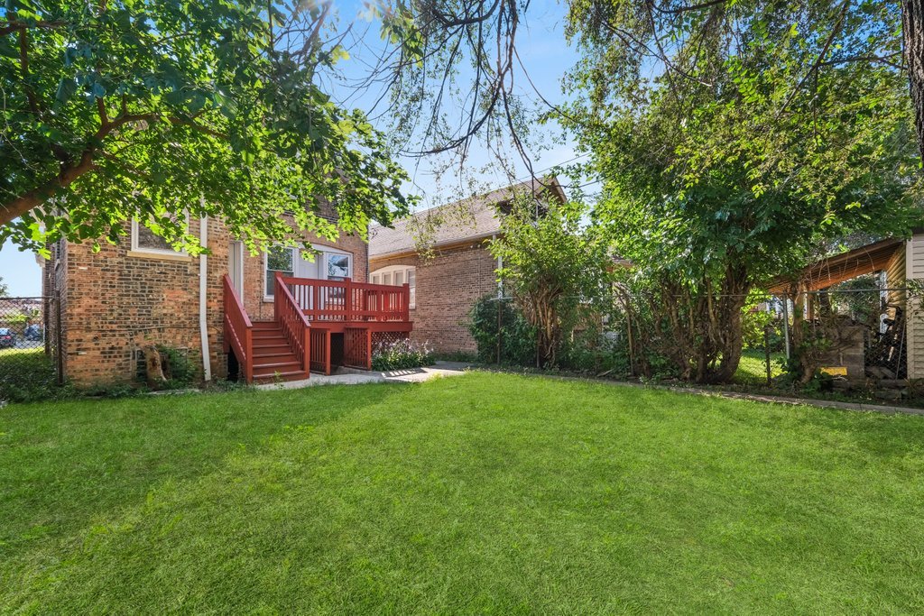 8014 South May Street Chicago, IL 60620 - Photo 48 of 50 a view of a backyard with table and chairs and a large tree