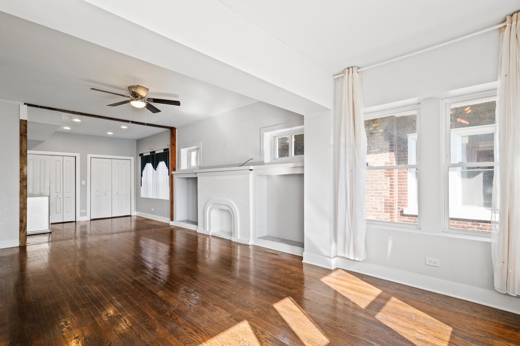8014 South May Street Chicago, IL 60620 - Photo 5 of 50 a view of empty room with wooden floor and fan