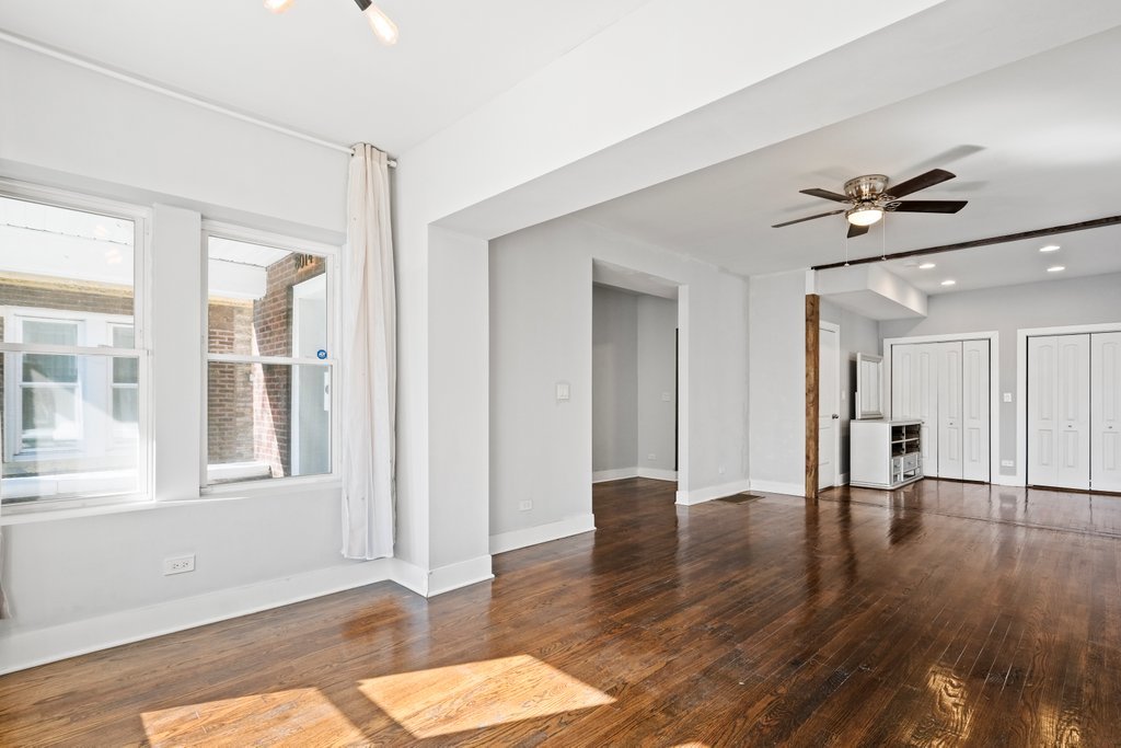 8014 South May Street Chicago, IL 60620 - Photo 6 of 50 a view of an empty room with window and wooden floor