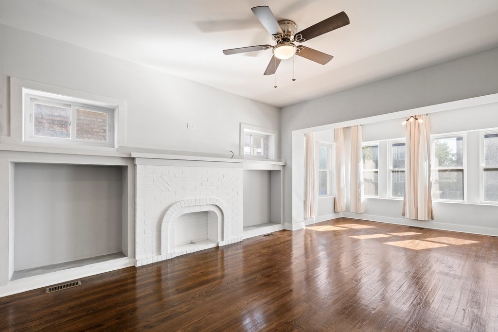 8014 South May Street Chicago, IL 60620 - Photo 10 of 50 a view of an empty room with window and wooden floor
