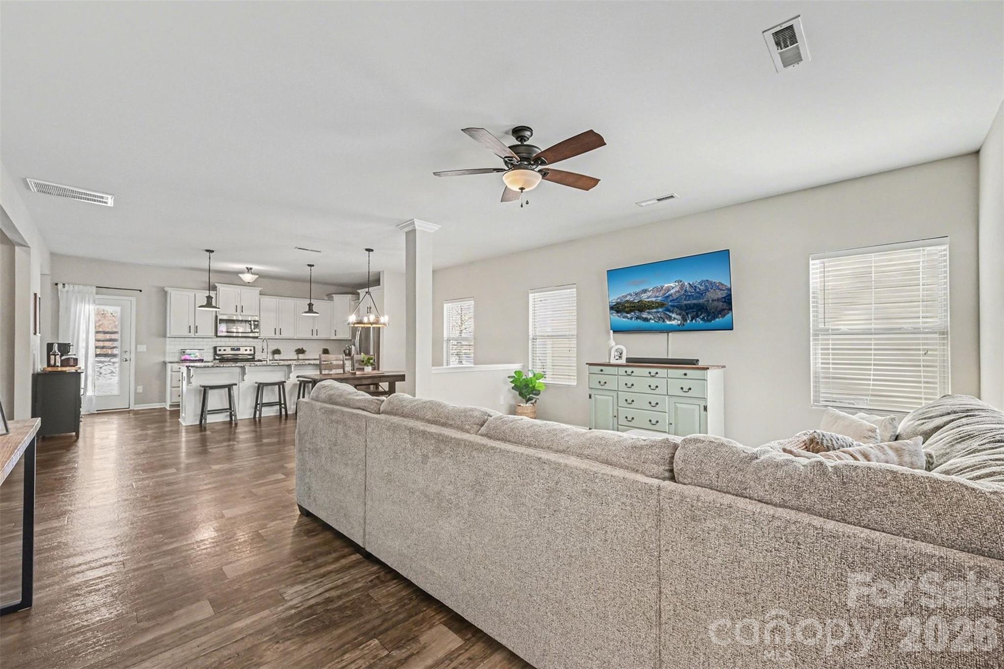 a living room with furniture and kitchen view