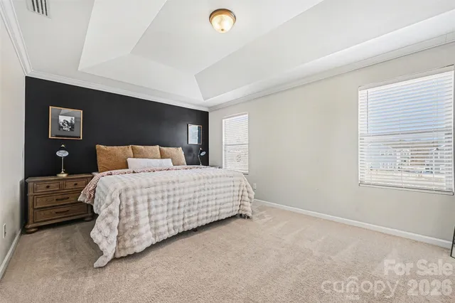 a bathroom with a granite countertop sink a toilet a mirror and shower