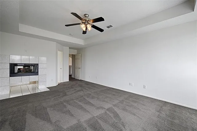 a view of a livingroom with a ceiling fan and window